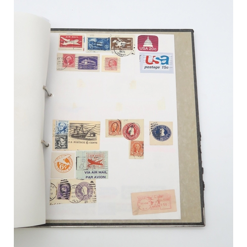 497A - A collection of USA stamps, with various commemorative and older examples, housed in a ring-bound fo... 