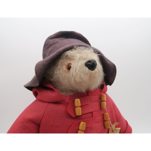 543 - A Paddington teddy bear by Gabrielle Designs, wearing red felt coat and Dunlop Wellington boots, ret... 