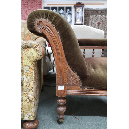 61 - A Victorian oak framed chaise longue with green velour upholstered seat, scroll end and back rail on... 