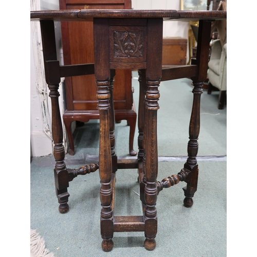 63 - A 20th century mahogany torchiere stand with circular top on reeded column on stepped base, 153cm hi... 