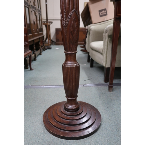 63 - A 20th century mahogany torchiere stand with circular top on reeded column on stepped base, 153cm hi... 