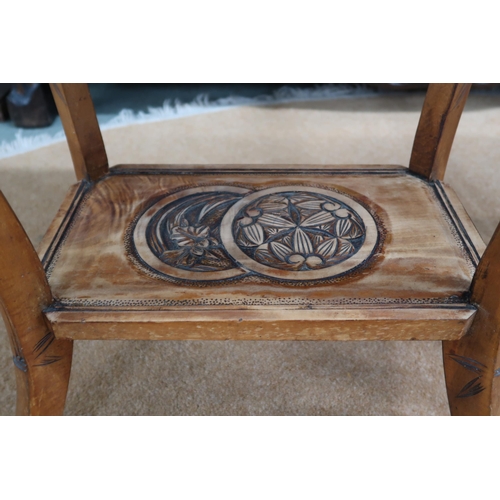 67 - An early 20th century oriental hardwood two tier occasional table with carved top on carved faux bam... 