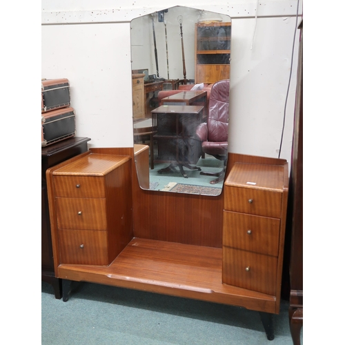 73 - A 20th century teak mirror backed dressing table with central mirror flanked by banks of three drawe... 