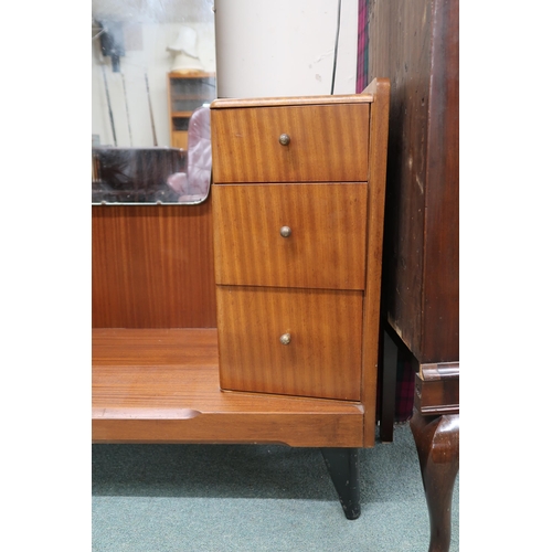 73 - A 20th century teak mirror backed dressing table with central mirror flanked by banks of three drawe... 