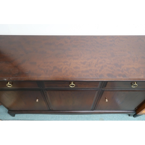 76 - A mid 20th century Stag minstrel sideboard with three drawers over three cabinet doors, 81cm high x ... 