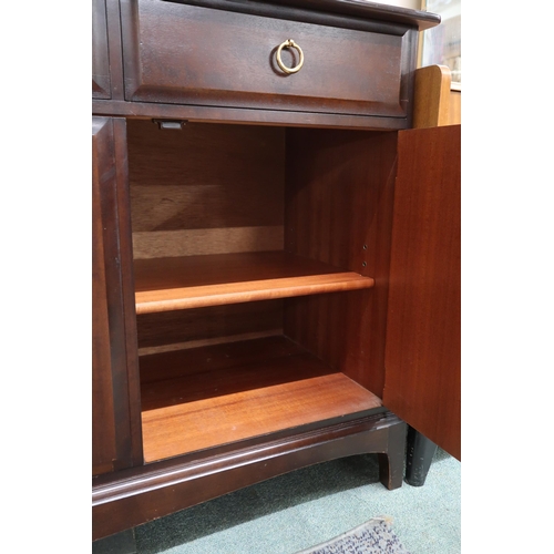 76 - A mid 20th century Stag minstrel sideboard with three drawers over three cabinet doors, 81cm high x ... 