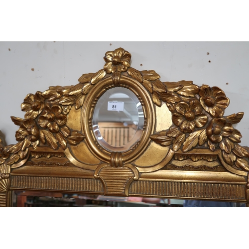 81 - A 20th century gilt framed rococo style wall mirror, 125cm high x 78cm wide 