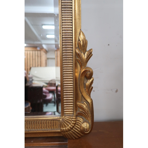 81 - A 20th century gilt framed rococo style wall mirror, 125cm high x 78cm wide 