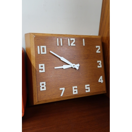 87 - A 20th century HMV model 1373 radio and a teak wall clock (2)