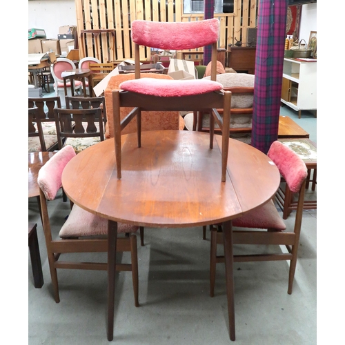 91 - A mid 20th century teak circular drop side dining table and three chairs (4)