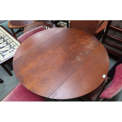 91 - A mid 20th century teak circular drop side dining table and three chairs (4)