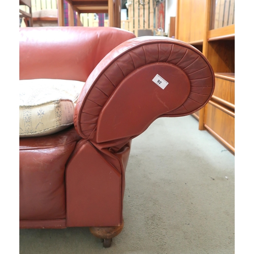 92 - A 20th century leather upholstered club style drop end settee with upholstered cushions, 73cm high x... 