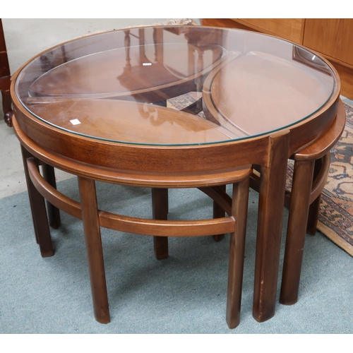 95 - A mid 20th century teak Nathan circular glass topped nesting coffee table, 51cm high x 82cm diameter