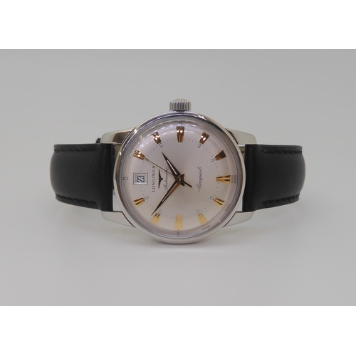 A LONGINES AUTOMATIC CONQUESTwith a silvered dial gold coloured