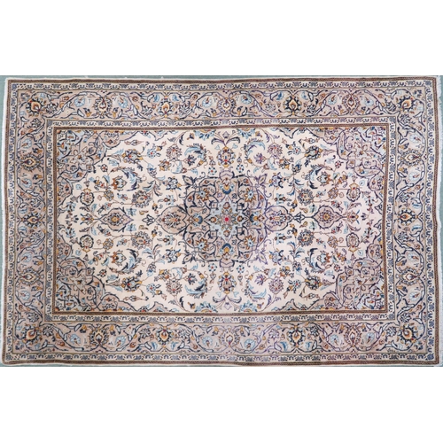 2137 - A CREAM GROUND TABRIZ RUG with blue and beige central medallion, matching spandrels and beige flower... 