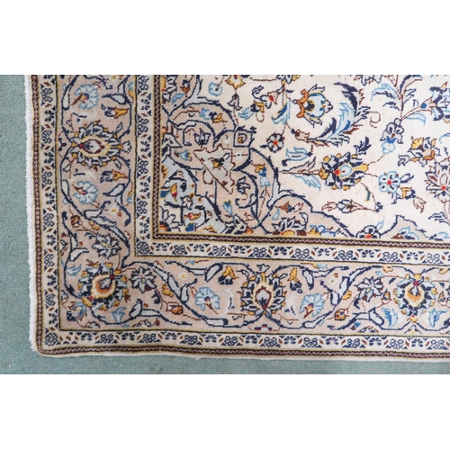 2137 - A CREAM GROUND TABRIZ RUG with blue and beige central medallion, matching spandrels and beige flower... 