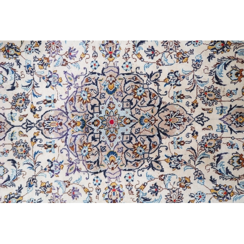 2137 - A CREAM GROUND TABRIZ RUG with blue and beige central medallion, matching spandrels and beige flower... 