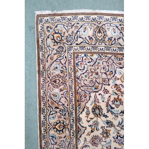 2137 - A CREAM GROUND TABRIZ RUG with blue and beige central medallion, matching spandrels and beige flower... 