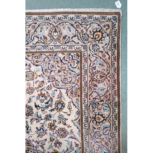 2137 - A CREAM GROUND TABRIZ RUG with blue and beige central medallion, matching spandrels and beige flower... 