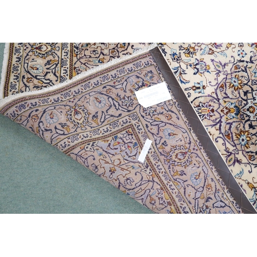 2137 - A CREAM GROUND TABRIZ RUG with blue and beige central medallion, matching spandrels and beige flower... 