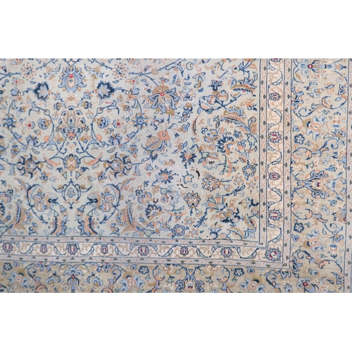 2138 - A PALE BLUE GROUND KASHAN RUG with cream and beige central medallion, floral pattern ground and beig... 