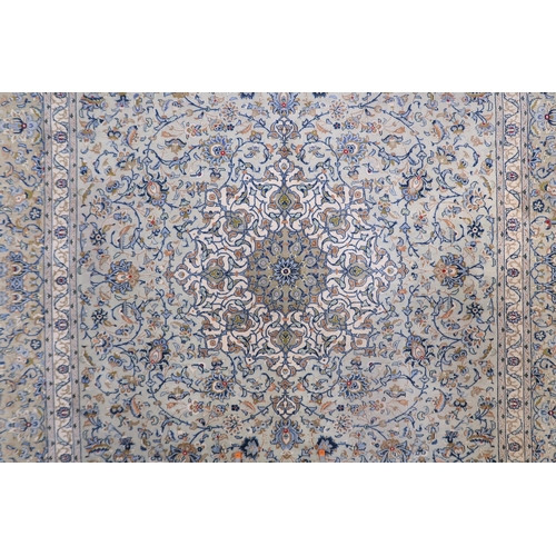 2138 - A PALE BLUE GROUND KASHAN RUG with cream and beige central medallion, floral pattern ground and beig... 