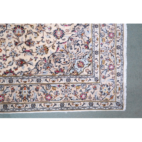 2139 - A CREAM GROUND KESHAN RUG with pale blue diamond shaped central medallion, matching spandrels on mul... 