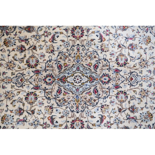 2139 - A CREAM GROUND KESHAN RUG with pale blue diamond shaped central medallion, matching spandrels on mul... 