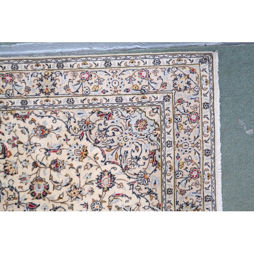 2139 - A CREAM GROUND KESHAN RUG with pale blue diamond shaped central medallion, matching spandrels on mul... 