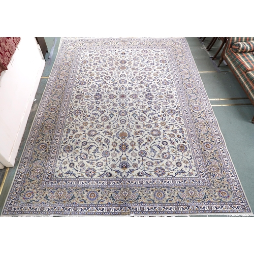 2140 - A PALE GREEN GROUND KASHAN RUG with all over floral pattern ground and multicoloured flower head bor... 