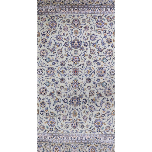 2140 - A PALE GREEN GROUND KASHAN RUG with all over floral pattern ground and multicoloured flower head bor... 