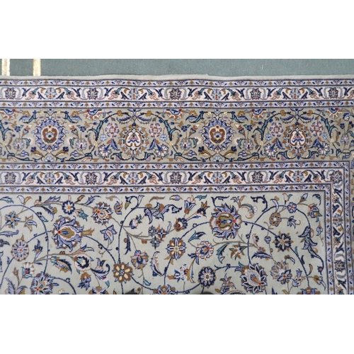 2140 - A PALE GREEN GROUND KASHAN RUG with all over floral pattern ground and multicoloured flower head bor... 