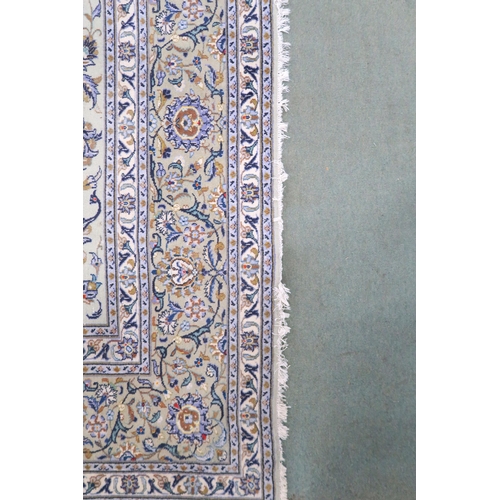 2140 - A PALE GREEN GROUND KASHAN RUG with all over floral pattern ground and multicoloured flower head bor... 