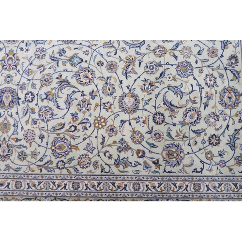 2140 - A PALE GREEN GROUND KASHAN RUG with all over floral pattern ground and multicoloured flower head bor... 