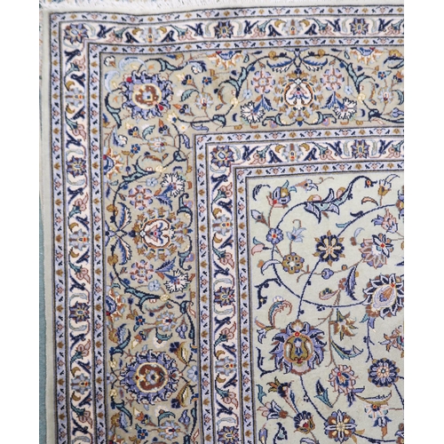 2140 - A PALE GREEN GROUND KASHAN RUG with all over floral pattern ground and multicoloured flower head bor... 