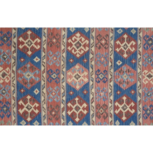 2141 - A MULTICOLOURED GROUND KILIM RUG with all over banded design with geometric medallions, 275cm long x... 