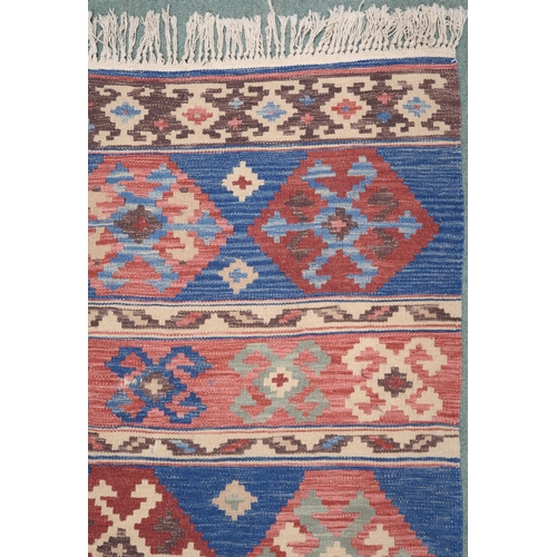 2141 - A MULTICOLOURED GROUND KILIM RUG with all over banded design with geometric medallions, 275cm long x... 