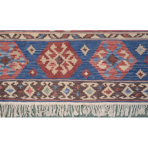 2141 - A MULTICOLOURED GROUND KILIM RUG with all over banded design with geometric medallions, 275cm long x... 