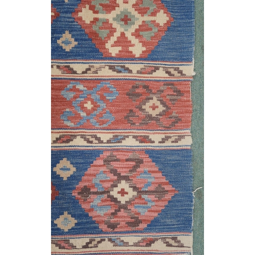 2141 - A MULTICOLOURED GROUND KILIM RUG with all over banded design with geometric medallions, 275cm long x... 