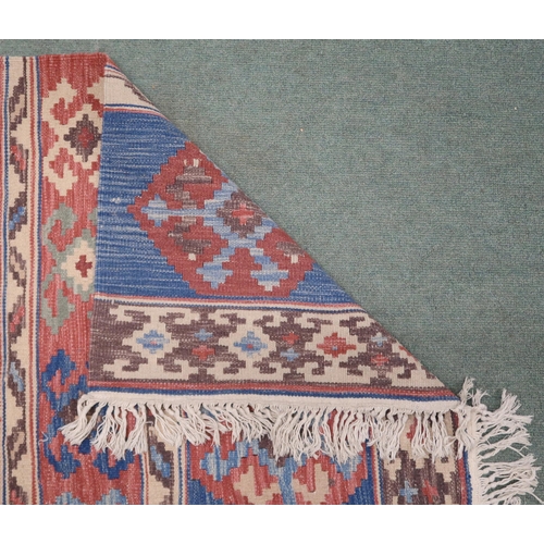 2141 - A MULTICOLOURED GROUND KILIM RUG with all over banded design with geometric medallions, 275cm long x... 