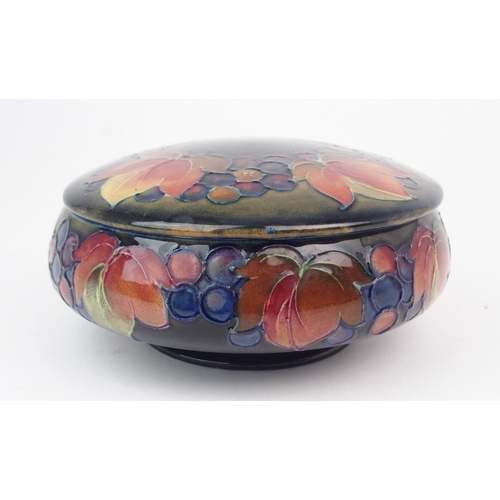 2157 - WILLIAM MOORCROFT A leaves and berries powder pot and cover, 15cm diameter, with impressed and paint... 