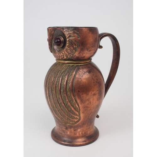 2193 - AN ARTS AND CRAFTS COPPER JUG in the form of an owl, with red glass eyes, 16cm high... 