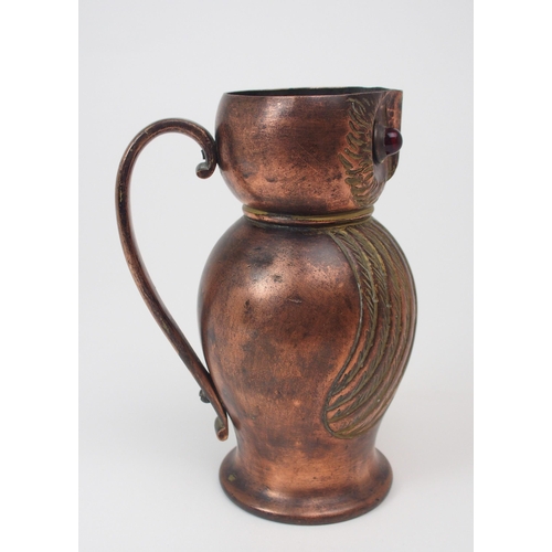 2193 - AN ARTS AND CRAFTS COPPER JUG in the form of an owl, with red glass eyes, 16cm high... 