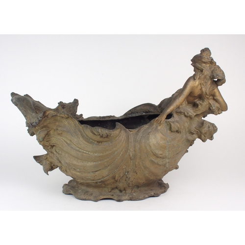 2218 - A SPELTER JARDINIERE moulded with a reclining maiden amongst waves with a fish to the other end, ind... 