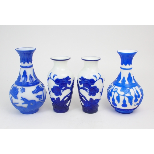 2393 - A COLLECTION OF MODERN PEKING GLASSincluding a pair of cobalt blue overlay examples, carved with flo... 