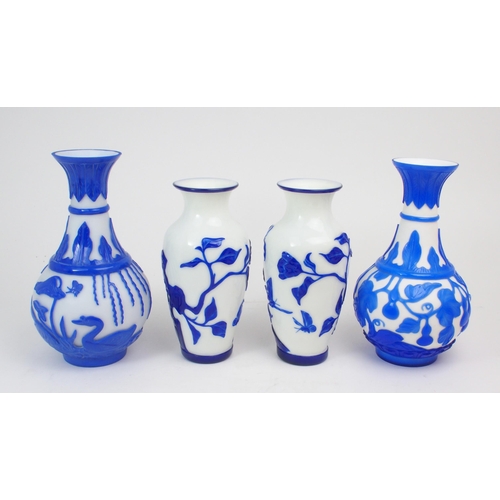 2393 - A COLLECTION OF MODERN PEKING GLASSincluding a pair of cobalt blue overlay examples, carved with flo... 