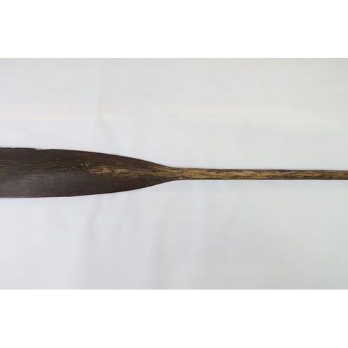 2397 - A PALMWOOD PADDLE, NEW IRELANDThe flared pommel with woven fibre covering, measuring approx. 99.5cm ... 