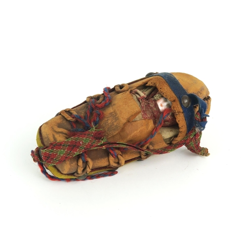 2398 - A PAPOOSE DOLL, NORTH AMERICAFormed of a buckskin outer covering with tacked wool felt banding, the ... 