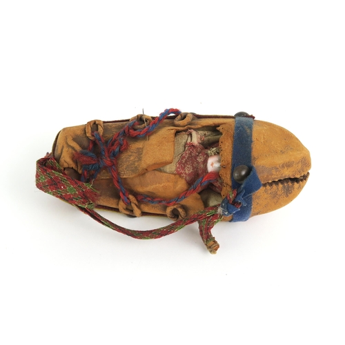 2398 - A PAPOOSE DOLL, NORTH AMERICAFormed of a buckskin outer covering with tacked wool felt banding, the ... 