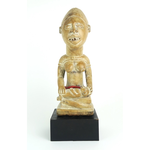 2399 - A MAYOMBE MOTHER AND BABY FIGURE, WEST CENTRAL AFRICACarved from a pale softwood, sat upon a later p... 